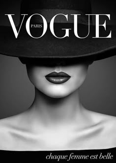 a woman wearing a black hat with the word voge on it's face