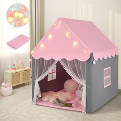 a pink and gray play tent with lights on the roof is shown in this image