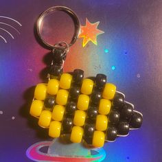 a keychain made out of legos on a table with a star in the background