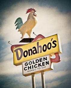 a sign that says donaho's with a rooster on top and the words golden chicken above it