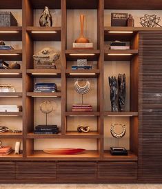 an open bookcase with many books and other items on the shelves in front of it