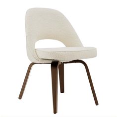 an upholstered chair with wooden legs and a white fabric seat pad on the back