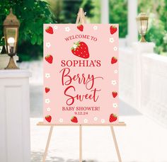 a welcome sign for a baby shower with strawberries on it