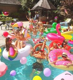 a group of people floating on inflatables and flamingos at a pool