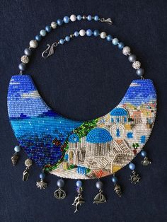 the beaded necklace is decorated with blue and white beads, which are hanging on a black background