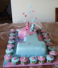 a birthday cake with cupcakes arranged in the shape of a heart