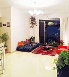 a living room filled with furniture and plants