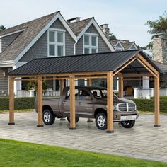 a truck is parked in front of a house with a carport attached to it