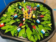 a tray filled with lots of green plants and scissors