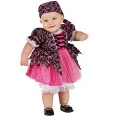 a baby dressed in a pink and black dress with a hat on it's head