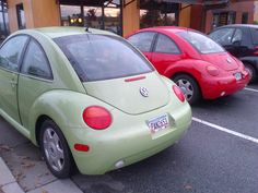 two cars parked next to each other in a parking lot