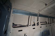 the inside of a vehicle with wires and other electrical equipment on the wall behind it