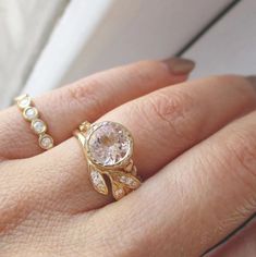 a close up of a person's hand with a gold ring and diamond band