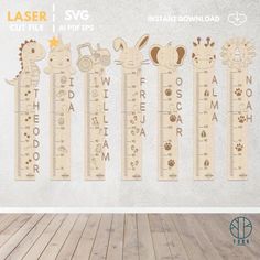 the wooden growth chart for children's room is shown with animals and letters on it