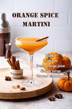 an orange spice martini is garnished with cinnamon