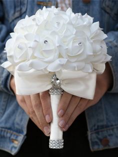 the bride's bouquet is made up of white flowers