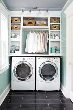 a washer and dryer in a laundry room with shelves on the wall above them