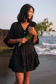 Our bestselling Rosetta Smock Dress is back in a brand new timeless hue. This organic cotton smock has a relaxed voluminous feel, and radiates an effortless beauty that is hard to look away from. Fit: True to size. Refer to our size guide below for specific size recommendation 100% GOTS Certified organic cotton Ethically made Hand dyed black hue Elastic cuff full length sleeves Double layered ra-ra skirt Elasticated waist Button down top Mini Length Cold hand wash only & hang to dry in shade Com Mid July, Effortless Beauty, Arm Cuff, Travel Inspired, Fine Jewels, New Shows, Smock Dress, Cuff Sleeves, Skirt Fashion