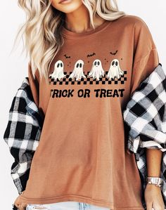 Get ready for Halloween with this adorable "Trick or Treat" Comfort Colors t-shirt featuring a cute ghost design! Perfect for spooky season, this shirt showcases four playful ghosts with a checkered pattern and bats flying above. The vintage-inspired design is printed on a soft, terracotta-colored tee, offering a comfortable, oversized fit. Whether you're heading to a Halloween party or enjoying a cozy night in, this shirt is the ideal choice for all your fall festivities. ★Processing Time: Approx. 1-7 business days (exceptions may occur during holiday seasons). ★Shipping Time: Separate from processing time, approx 2-5 business days. Check estimated delivery times at checkout. Upgrade shipping at checkout if needed sooner. Expedited Shipping: 2-3 business days. ★Shipping Address: Ensure th Spooky Cartoon Print T-shirt For Fall, Fall Spooky Cartoon Print T-shirt, Cute Halloween Shirt With Graphic Print, Cute Halloween Graphic Print Shirt, Spooky Long Sleeve Shirt With Letter Print, Long Sleeve Shirt With Letter Print In Spooky Style, Fall Graphic Tee, Bats Flying, Ghost Trick