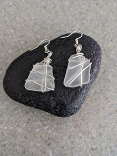 Wire Wrapped White Frosted Beach Glass Earrings These beautiful earrings are from Lake Michigan! They are authentic, white frosted glass and each piece is paired with 20 gage artistic wire wrap. The earrings are sterling and come with pushback closures. Imagine these sparkling pieces of beach glass started out as tossed used bottles  in to Lake Michigan. They naturally tumbled in the lake and washed back up as beautifully shaped frosted glass. They are a wonderful gift for the beach girl, birthd Beach Glass Necklace, Artistic Wire, Glass Christmas Ornaments, Beach Glass, Lake Michigan, Glass Earrings, Glass Necklace, Beach Girl, Wire Wrap