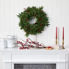 a christmas wreath is hanging on the fireplace mantel