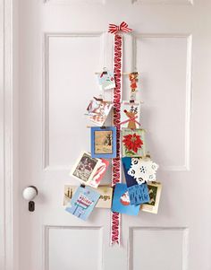 a door with a christmas tree hanging from it's side next to a white door