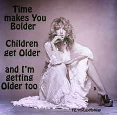 a woman sitting on the ground in front of a sign that says time makes you bolder children get older and i'm getting older too