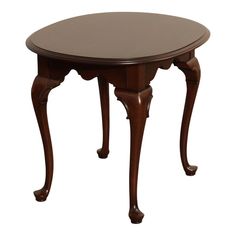 a wooden table with an oval shaped top