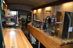 the inside of an rv with wood counter tops and stainless steel appliances on each side