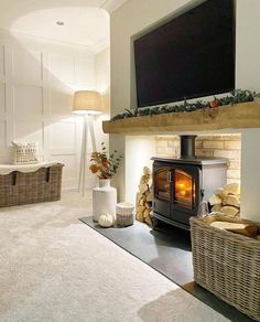 a living room filled with furniture and a flat screen tv mounted above a fire place