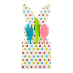 an easter bunny napkin holder with forks and spoons in polka dot pattern, isolated against a white background