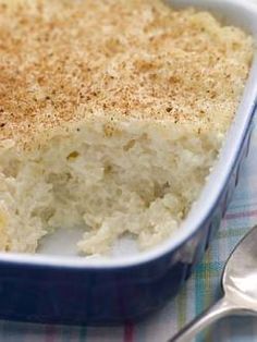 a casserole dish filled with rice on top of a checkered table cloth