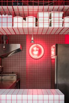 a kitchen with red lights on the wall