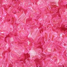 pink glass cubes are piled together in a pile