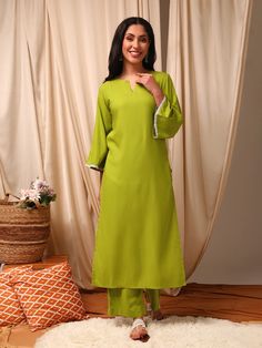 This green Kurta with Trousers set is made from a luxurious silk blend fabric, creating a stylish and comfortable outfit. The Kurta features a straight shape and round neck with flared three-quarter sleeves, while the Trousers have a partially elasticated waistband and slip-on closure for ease of wear. With a calf leng Summer Viscose Workwear Sets, Summer Workwear Sets In Viscose, Summer Workwear Viscose Sets, Spring Long Sleeve Rayon Sets, Festive Green Long Sleeve Pant Set, Summer Sets With 3/4 Sleeve, Eid Workwear Palazzo Set With Long Sleeves, Elegant Green Summer Pant Set, Elegant Summer Sets With 3/4 Sleeve