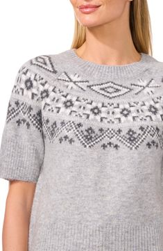 A pretty Fair Isle pattern warms this cozy pullover knit with short sleeves that makes for versatile wear during sweater season and beyond. Crewneck Short sleeves Ribbed cuffs and hem Acrylic/polyester/spandex Hand wash, dry flat Imported