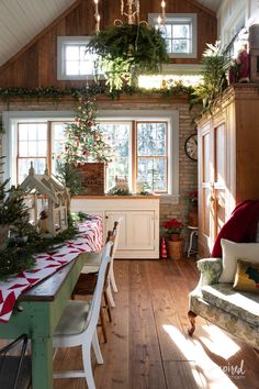 a dining room filled with lots of furniture and christmas decorations on top of the table