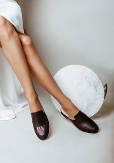 A mule that is all about you. Our Monogram Collection is specially personalized with your choice of monogram. Choose any monogram (up to 12 characters) such as a name, message, date, or initials for you or a loved one. Details: Slip on, closed-toe mule. Slight heel. Sizing: True to size. If you are a true half size, we recommend sizing down. If you are unsure of your size, please refer to our size chart. Click Here To Shop Monogram Collection Click Here For Our Monogram Menu Painted by hand. 100 Painted Leather Shoes, Black Mule, Black Mules, Hand Painted Shoes, Painting Leather, Shoe Art, Black Leather Shoes, How To Make Shoes, 2 Inch Heels