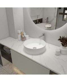 a white bathroom sink sitting on top of a counter