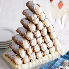 a stack of cookies sitting on top of a table next to plates and silverware