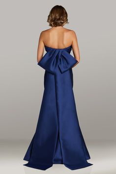 the back of a woman in a blue gown