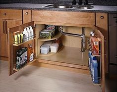 an open cabinet in the middle of a kitchen