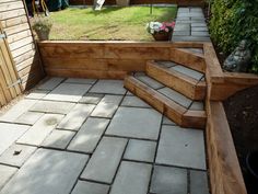 a stone patio with steps leading up to it