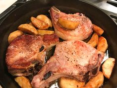 pork chops and potatoes in a cast iron skillet