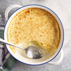 a close up of a bowl of food on a table with a spoon in it