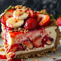 a piece of cheesecake with strawberries and bananas on top