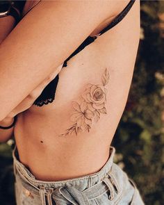 a woman with a flower tattoo on her stomach