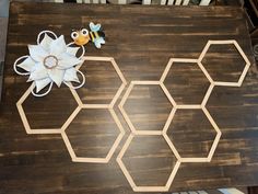 the table is made out of wood and has flowers on it, including a bee