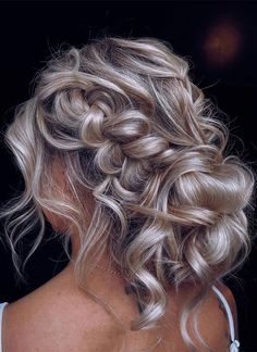 the back of a woman's head with blonde hair styled into a half - updo