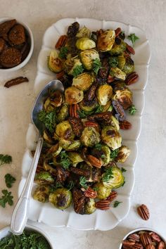 roasted brussel sprouts with pecans and walnuts on a platter